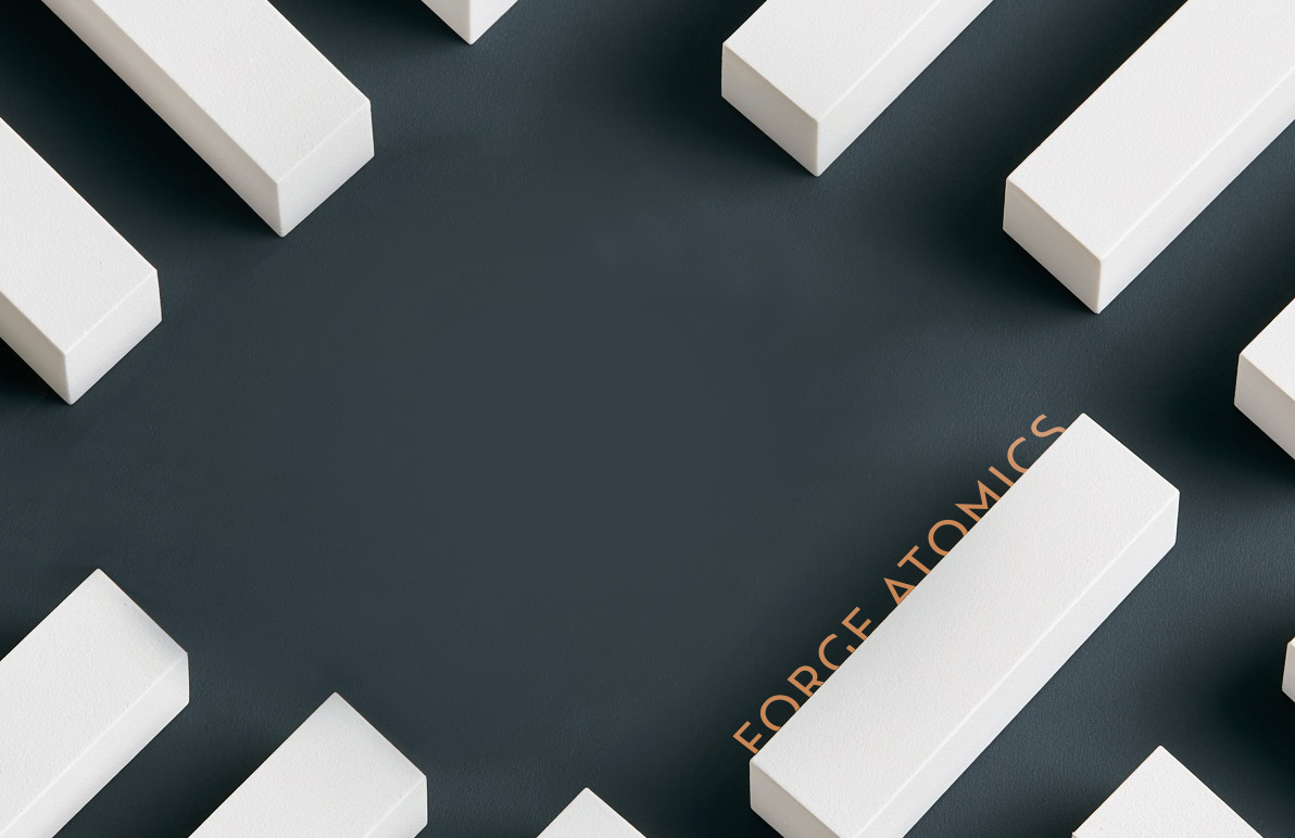 Identical white rectangular modules arranged in a repeating array on a graphite surface
